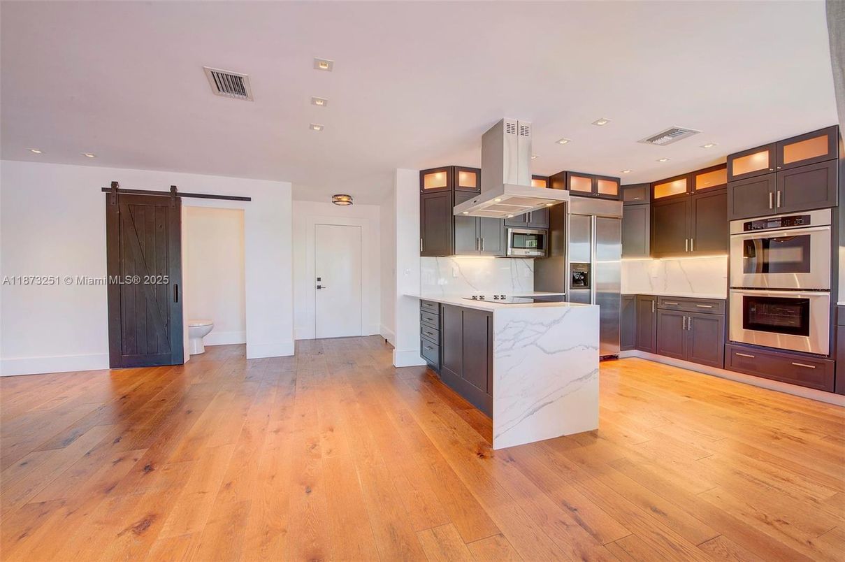 Interior, Kitchen, Marble Walls, Recessed Lighting, Stainless Steel Appliances, Wood Texture Flooring