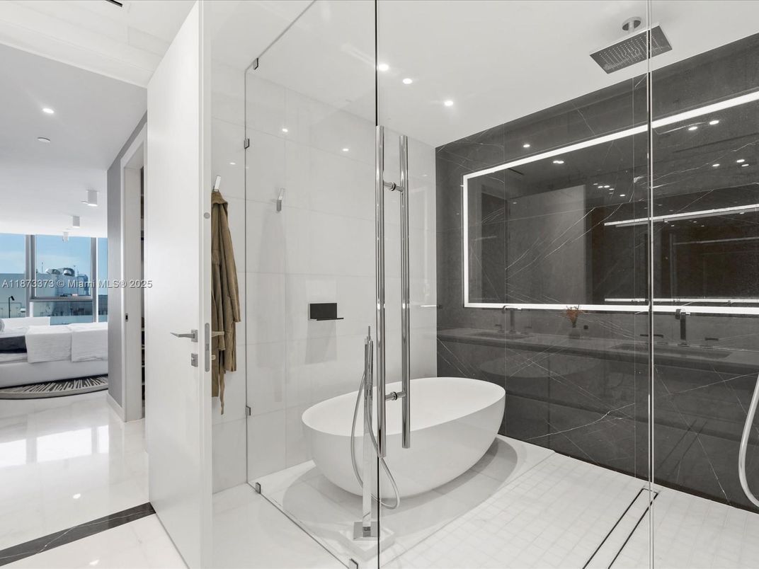 Bathroom, Free Standing Baths, Glass Shower, Interior, Marble Walls, Recessed Lighting, Water