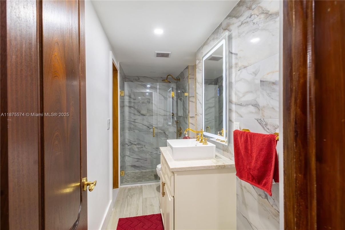 Bathroom, Glass Shower, Interior, Marble Walls, Recessed Lighting, Wood Texture Flooring