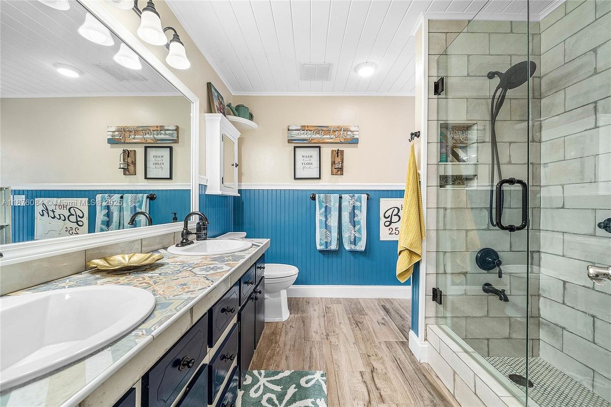 Bathroom, Dual Sink Vanities, Glass Shower, Interior, Recessed Lighting, Tile Countertops, Wood Texture Flooring