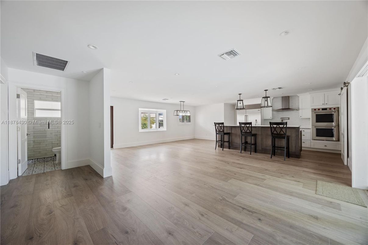 Empty room, Interior, Kitchen, Pendant Lights, Recessed Lighting, Stainless Steel Appliances, Wood Texture Flooring