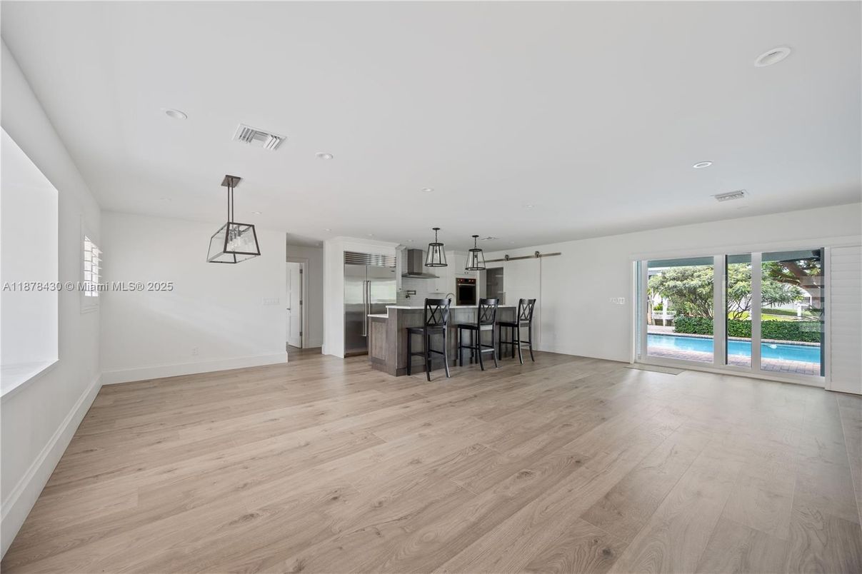 Empty room, Interior, Kitchen, Pendant Lights, Recessed Lighting, Stainless Steel Appliances, Wood Texture Flooring