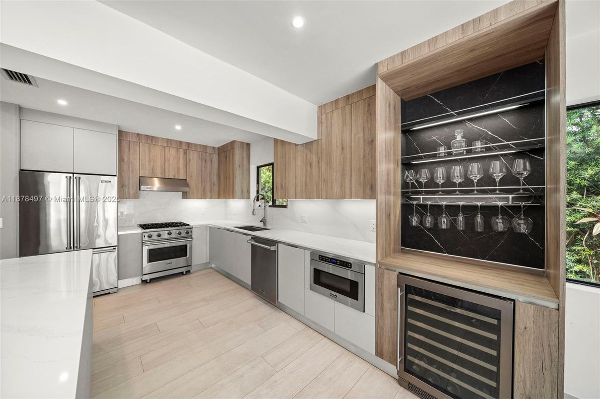 Interior, Kitchen, Marble Walls, Recessed Lighting, Stainless Steel Appliances, Wood Texture Flooring