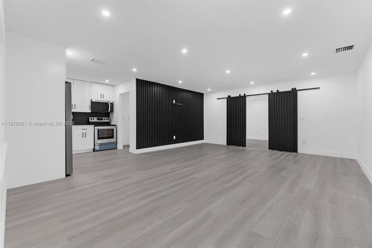 Empty room, Interior, Kitchen, Recessed Lighting, Stainless Steel Appliances, Wood Texture Flooring