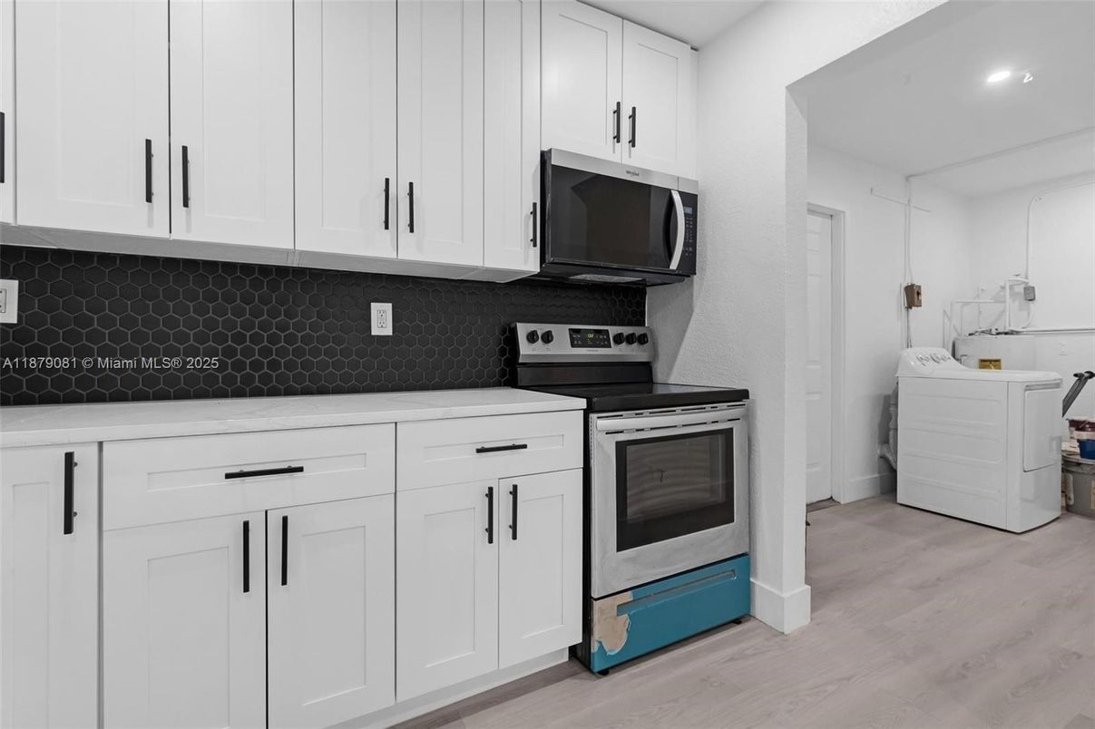 Interior, Kitchen, Recessed Lighting, Washer, Wood Texture Flooring