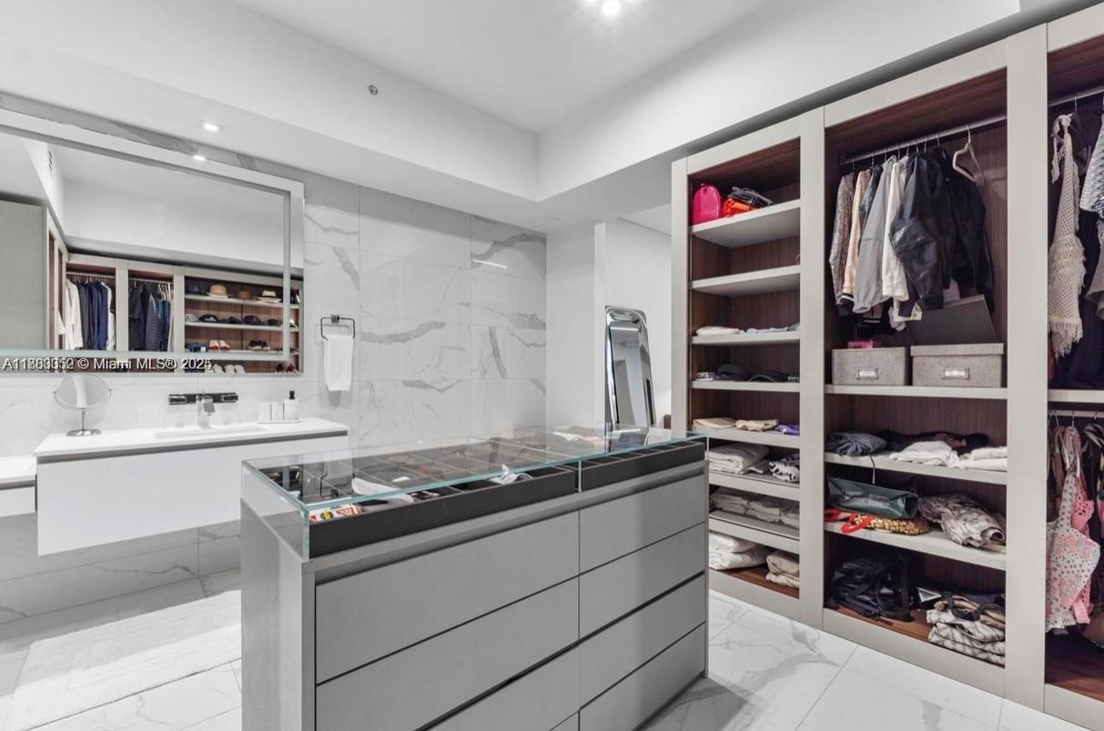 Bathroom, Dual Sink Vanities, Interior, Marble, Marble Walls, Recessed Lighting, Walk-in Closets