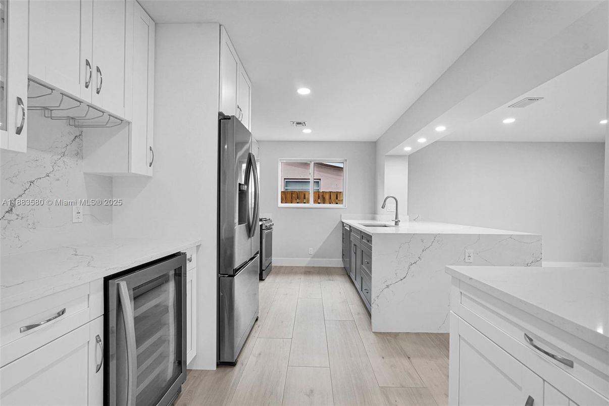 Interior, Kitchen, Marble Walls, Recessed Lighting, Stainless Steel Appliances, Wood Texture Flooring