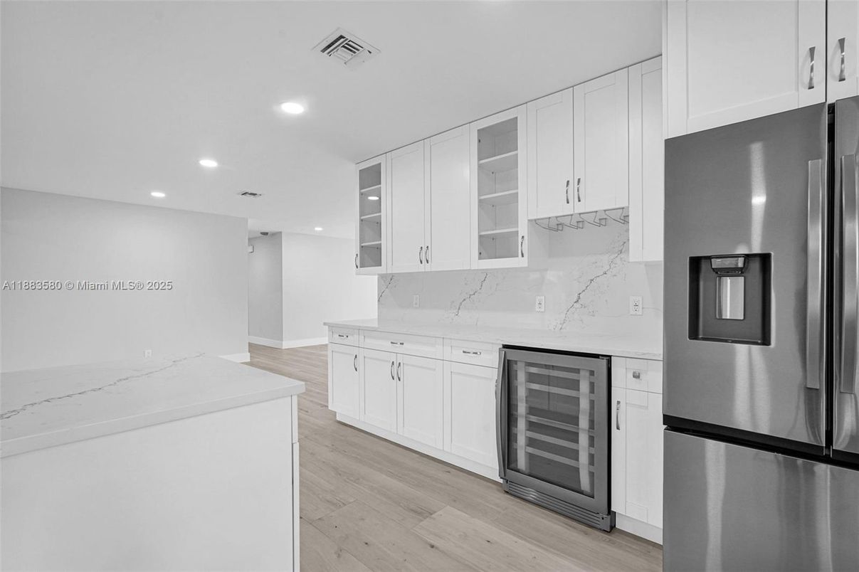 Interior, Kitchen, Marble Walls, Recessed Lighting, Stainless Steel Appliances, Wood Texture Flooring
