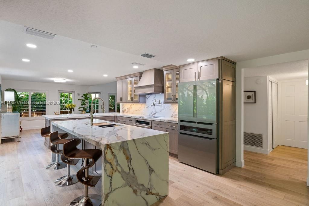 Interior, Kitchen, Marble Walls, Recessed Lighting, Stainless Steel Appliances, Wood Texture Flooring