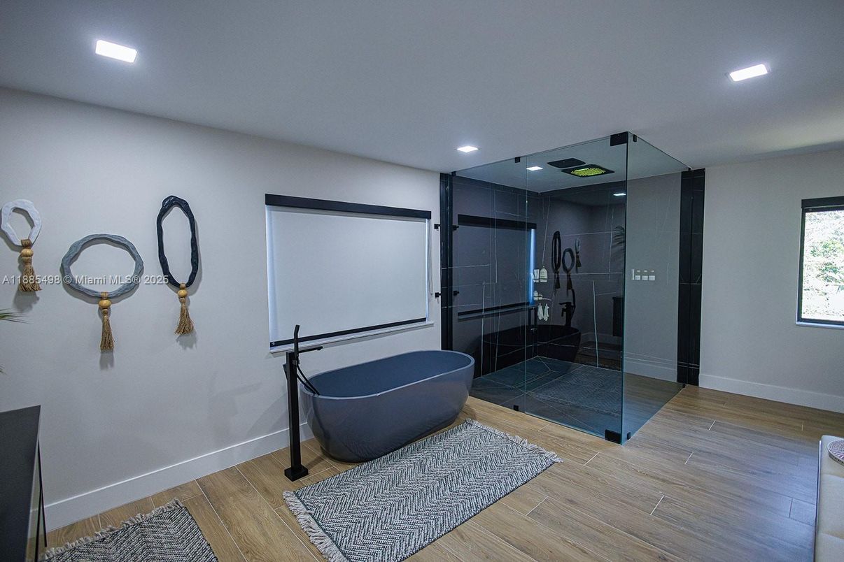 Bathroom, Free Standing Baths, Glass Shower, Interior, Projection Screen, Recessed Lighting, Wood Texture Flooring
