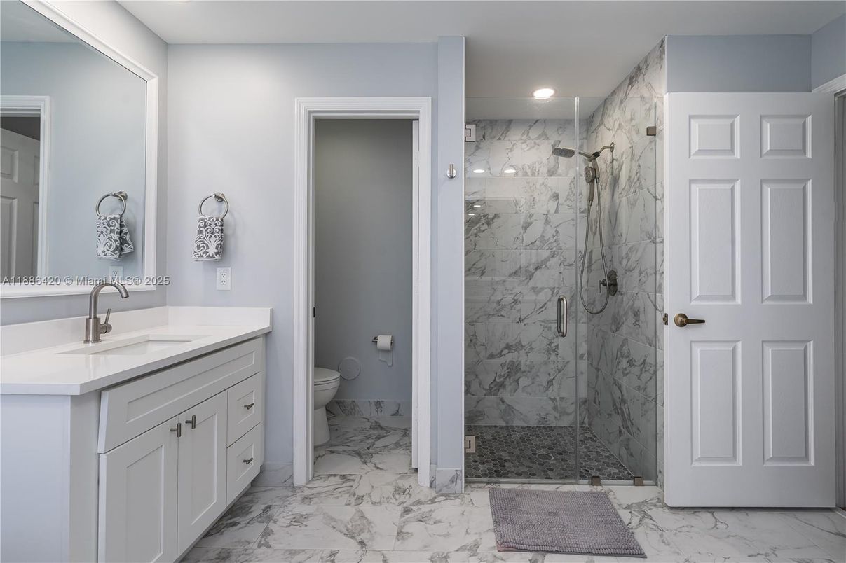 Bathroom, Dual Sink Vanities, Glass Shower, Interior, Marble, Marble Walls, Recessed Lighting