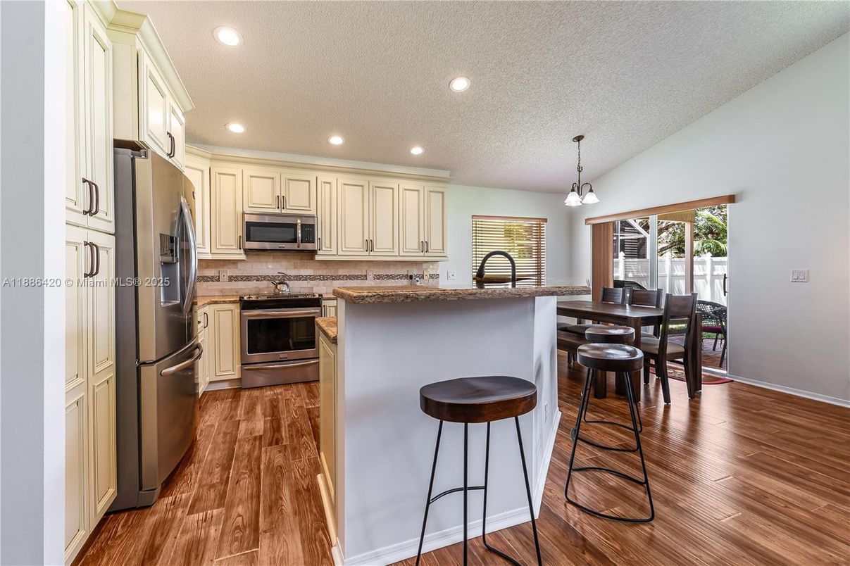 Dining room, Interior, Kitchen, Pendant Lights, Recessed Lighting, Stainless Steel Appliances, Wood Texture Flooring