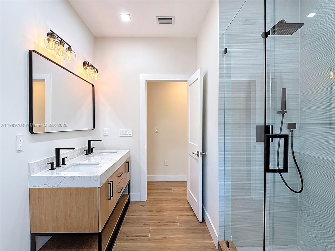 Bathroom, Dual Sink Vanities, Glass Shower, Interior, Recessed Lighting, Wood Texture Flooring