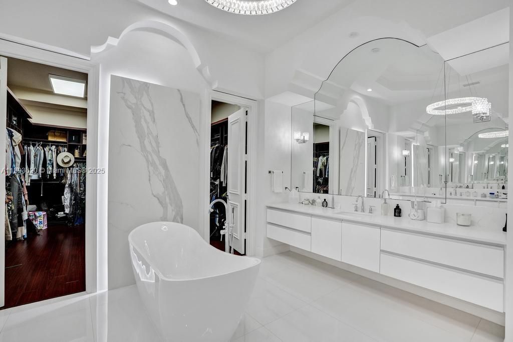 Bathroom, Dual Sink Vanities, Free Standing Baths, Interior, Marble Walls, Pendant Lights, Recessed Lighting, Walk-in Closets, Wood Texture Flooring