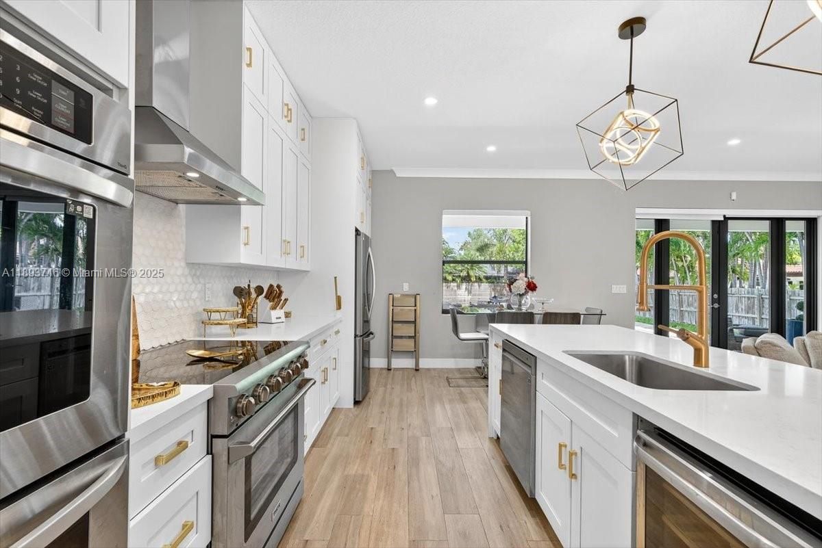 Dining room, Interior, Kitchen, Pendant Lights, Recessed Lighting, Stainless Steel Appliances, Wood Texture Flooring