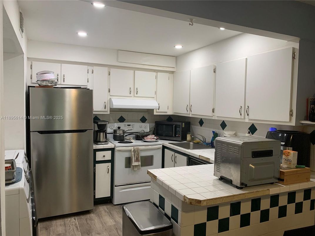 Interior, Kitchen, Recessed Lighting, Stainless Steel Appliances, Tile Countertops, Wood Texture Flooring