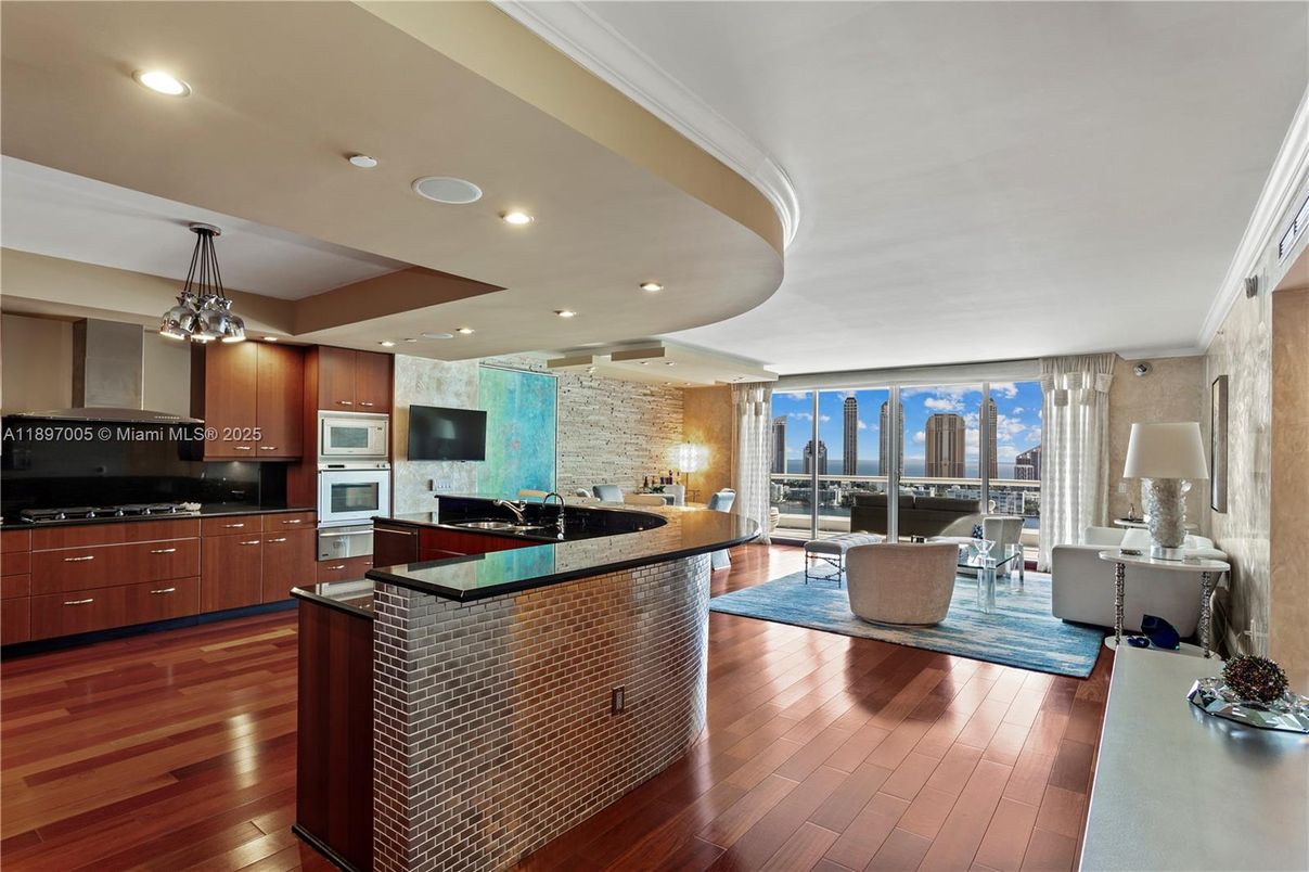 Dining room, Interior, Kitchen, Living room, Pendant Lights, Recessed Lighting, Stainless Steel Appliances, Stone Walls, Wood Texture Flooring