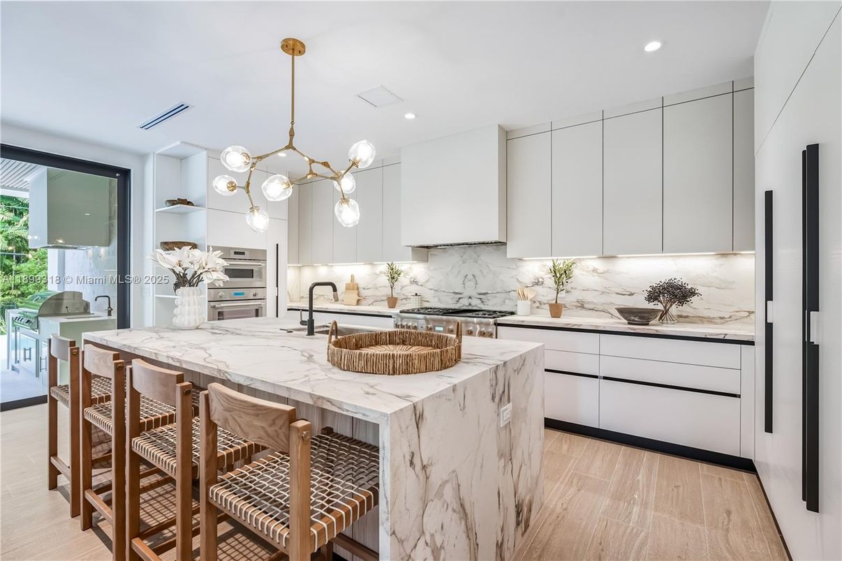 Interior, Kitchen, Marble Walls, Pendant Lights, Recessed Lighting, Stainless Steel Appliances, Wood Texture Flooring