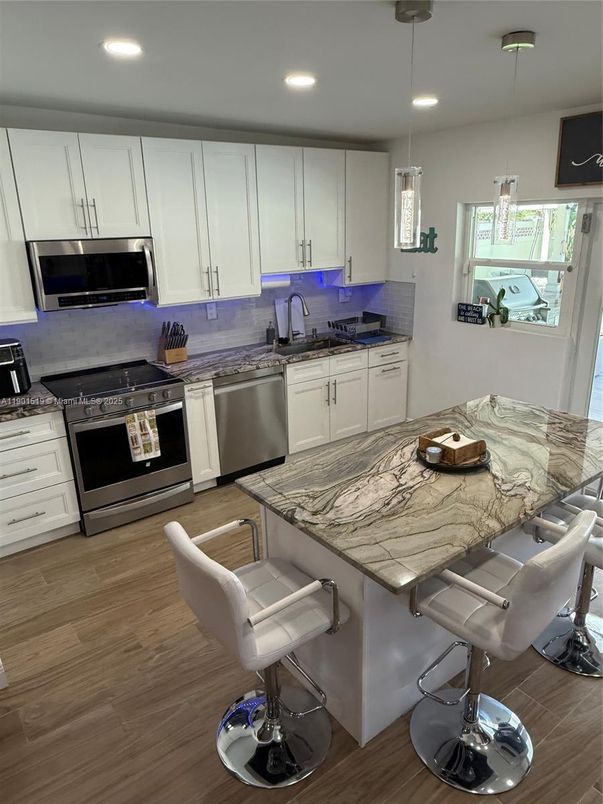Dining room, Interior, Kitchen, Pendant Lights, Recessed Lighting, Stainless Steel Appliances, Wood Texture Flooring