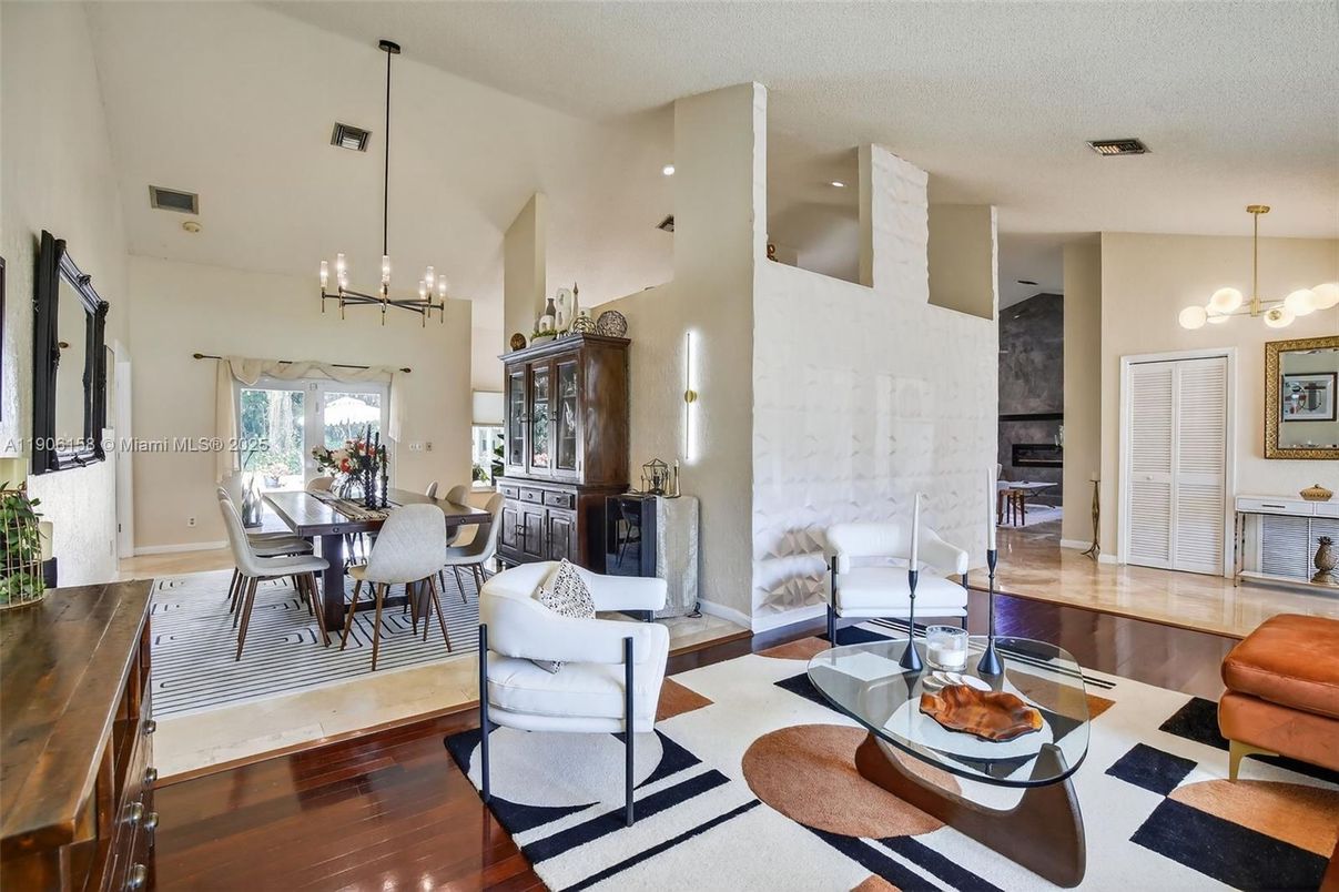 Chandelier, Dining room, Fireplace, Interior, Living room, Pendant Lights, Recessed Lighting, Wood Texture Flooring