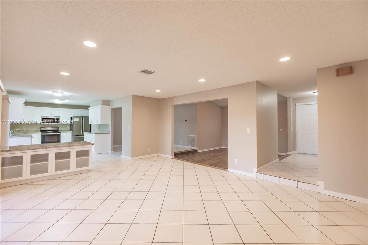 Empty room, Interior, Kitchen, Recessed Lighting, Stainless Steel Appliances, Wood Texture Flooring