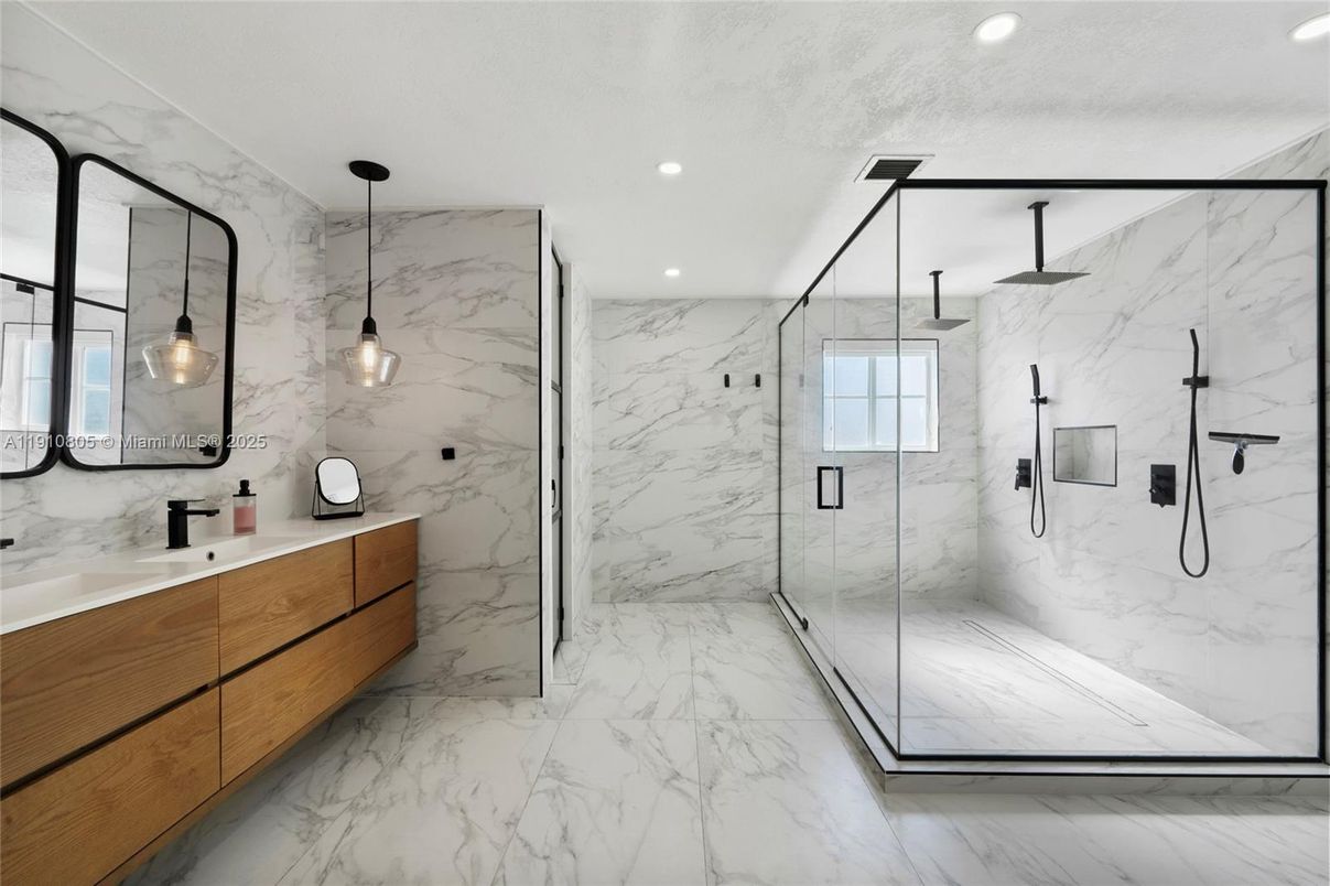 Bathroom, Dual Sink Vanities, Glass Shower, Interior, Marble, Marble Walls, Pendant Lights, Recessed Lighting