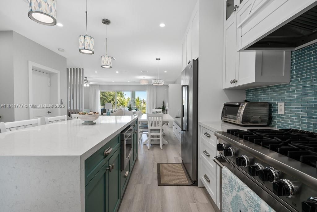 Dining room, Interior, Kitchen, Pendant Lights, Recessed Lighting, Stainless Steel Appliances, Wood Texture Flooring