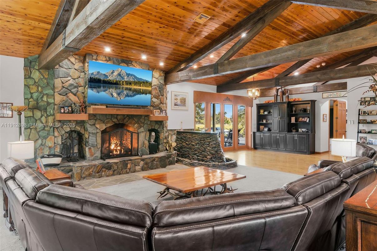Chandelier, Fireplace, Interior, Living room, Recessed Lighting, Stone Walls, Wooden Beams, Wooden Ceilings, Wood Texture Flooring
