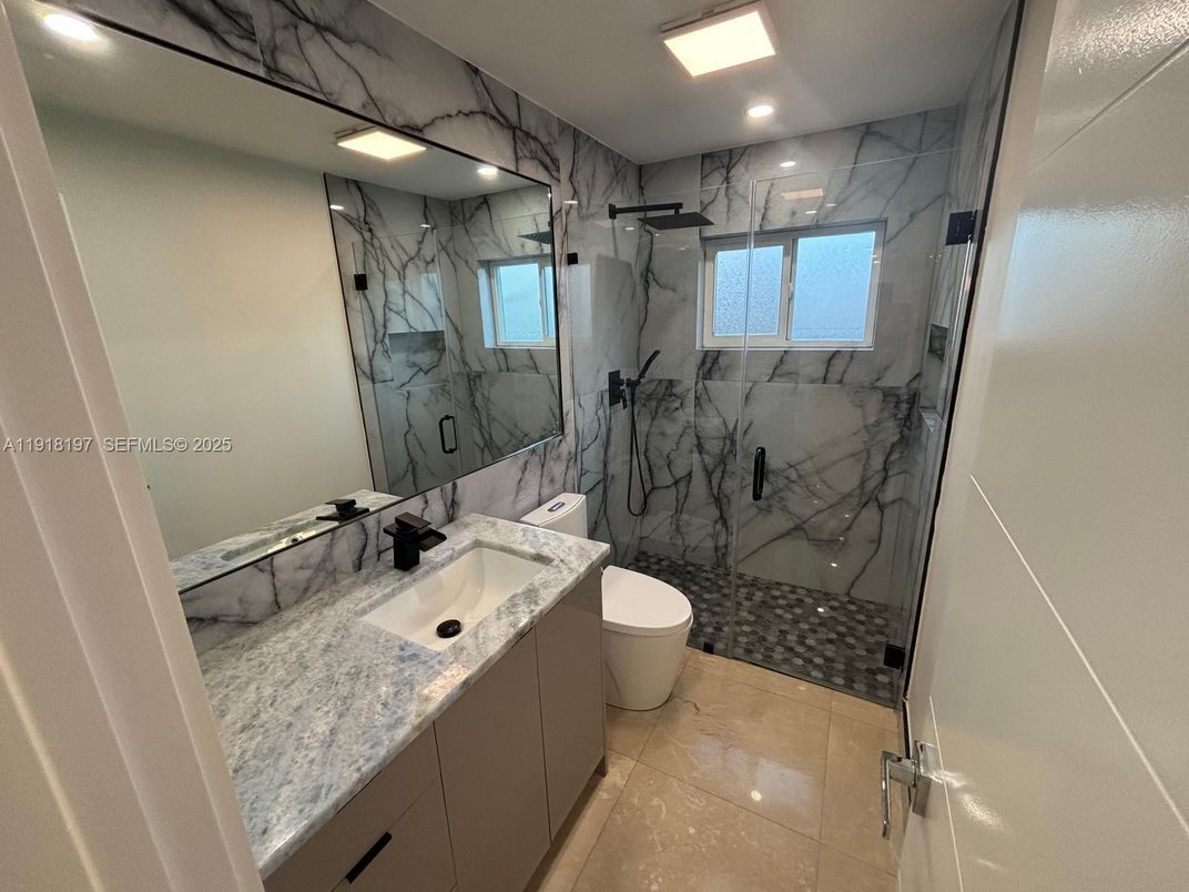 Bathroom, Dual Sink Vanities, Glass Shower, Interior, Marble Walls, Recessed Lighting