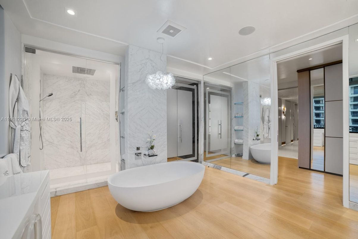 Bathroom, Free Standing Baths, Glass Shower, Interior, Marble Walls, Pendant Lights, Recessed Lighting, Wood Texture Flooring