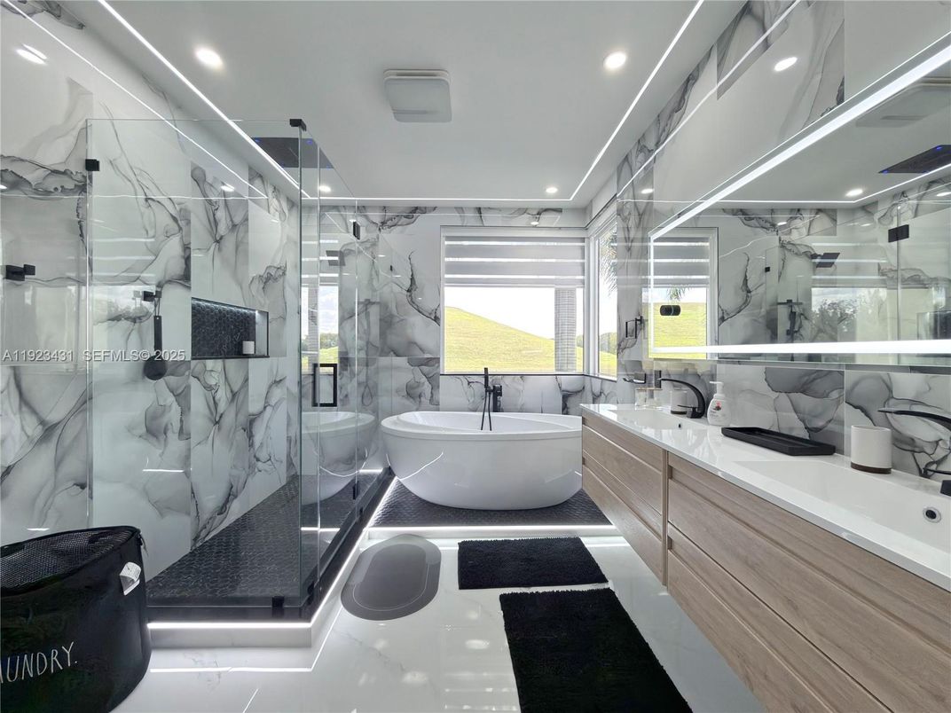 Bathroom, Dual Sink Vanities, Free Standing Baths, Glass Shower, Interior, Marble Walls, Recessed Lighting