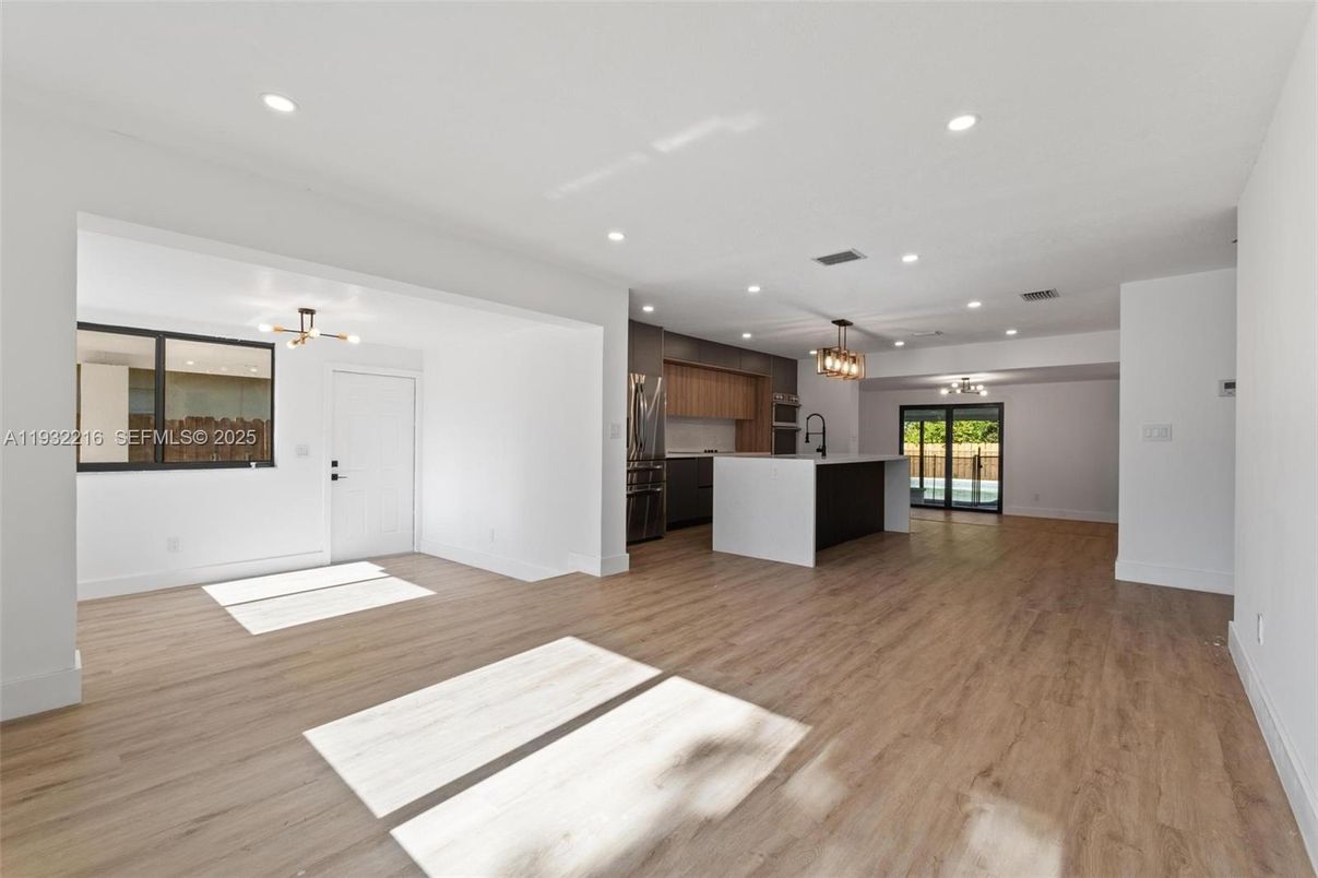 Chandelier, Empty room, Interior, Kitchen, Pendant Lights, Recessed Lighting, Stainless Steel Appliances, Wood Texture Flooring