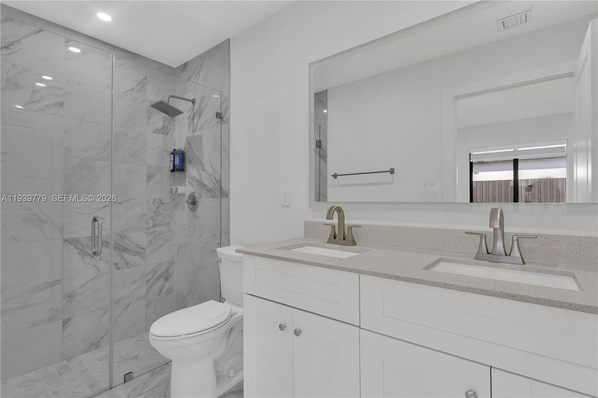 Bathroom, Dual Sink Vanities, Glass Shower, Interior, Marble, Marble Walls, Recessed Lighting