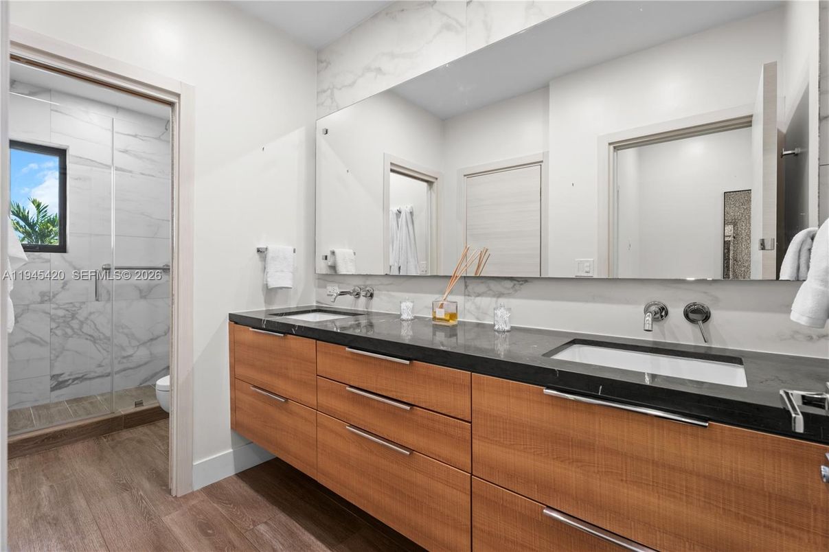 Bathroom, Dual Sink Vanities, Glass Shower, Interior, Marble Walls, Wood Texture Flooring