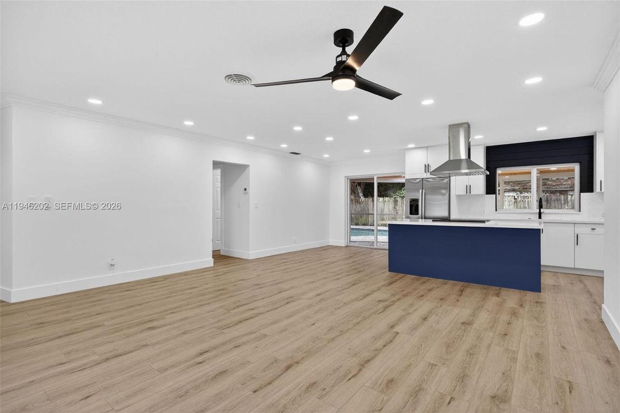 Empty room, Interior, Kitchen, Recessed Lighting, Stainless Steel Appliances, Wood Texture Flooring