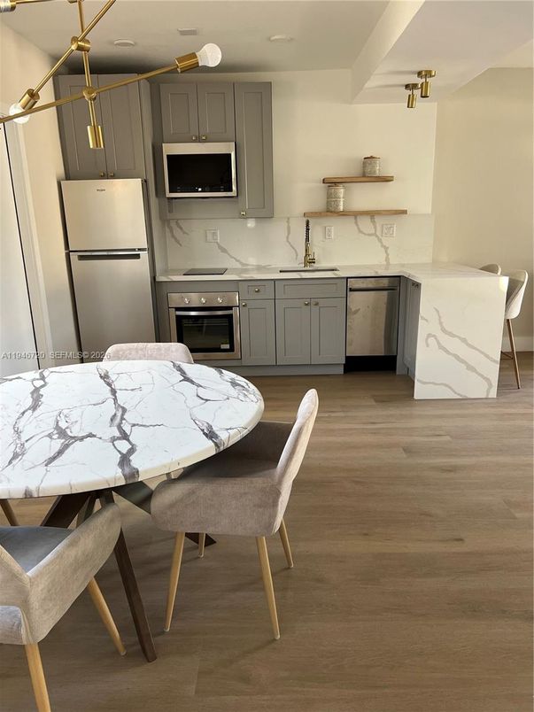 Dining room, Interior, Kitchen, Marble Walls, Pendant Lights, Stainless Steel Appliances, Wood Texture Flooring