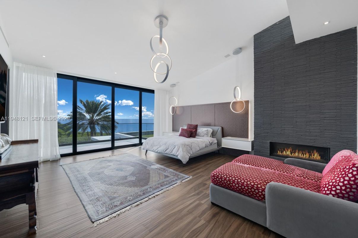 Bedroom, Fireplace, Interior, Pendant Lights, Recessed Lighting, Water, Wood Texture Flooring