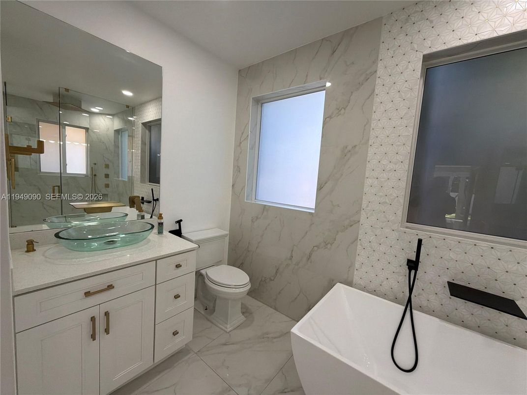 Bathroom, Dual Sink Vanities, Glass Shower, Interior, Marble, Marble Walls, Recessed Lighting
