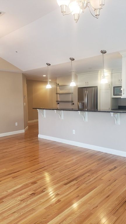 Empty room, Interior, Kitchen, Pendant Lights, Stainless Steel Appliances, Wood Texture Flooring
