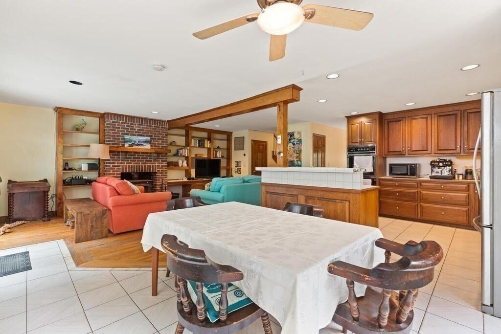 Dining room, Fireplace, Interior, Kitchen, Living room, Recessed Lighting, Stone Walls, Wood Texture Flooring