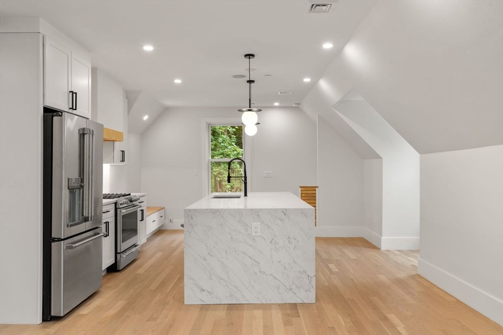 Interior, Kitchen, Marble Walls, Pendant Lights, Recessed Lighting, Stainless Steel Appliances, Wood Texture Flooring