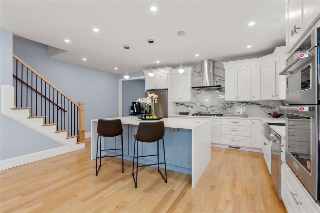 Interior, Kitchen, Marble Walls, Pendant Lights, Recessed Lighting, Stainless Steel Appliances, Wood Texture Flooring