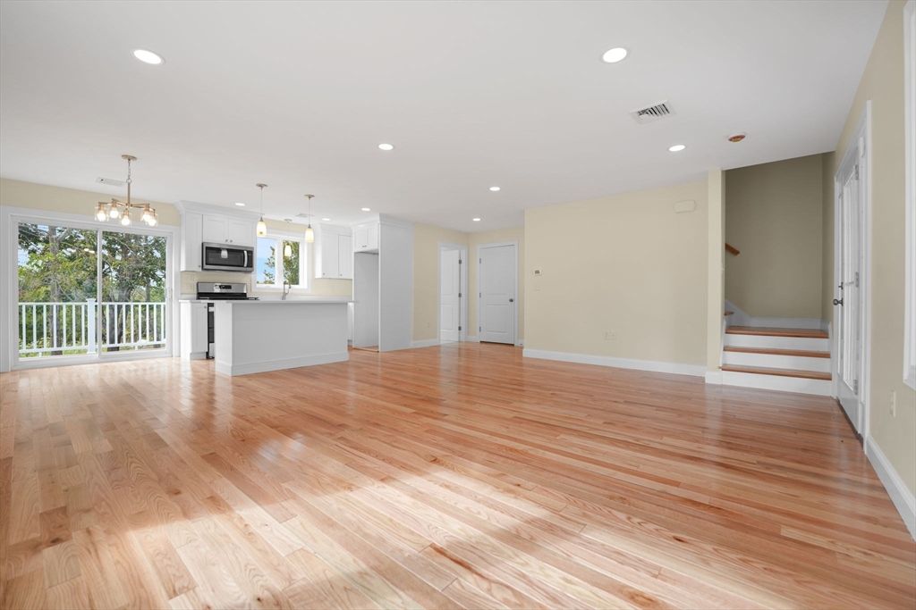 Empty room, Interior, Kitchen, Pendant Lights, Recessed Lighting, Stainless Steel Appliances, Wood Texture Flooring