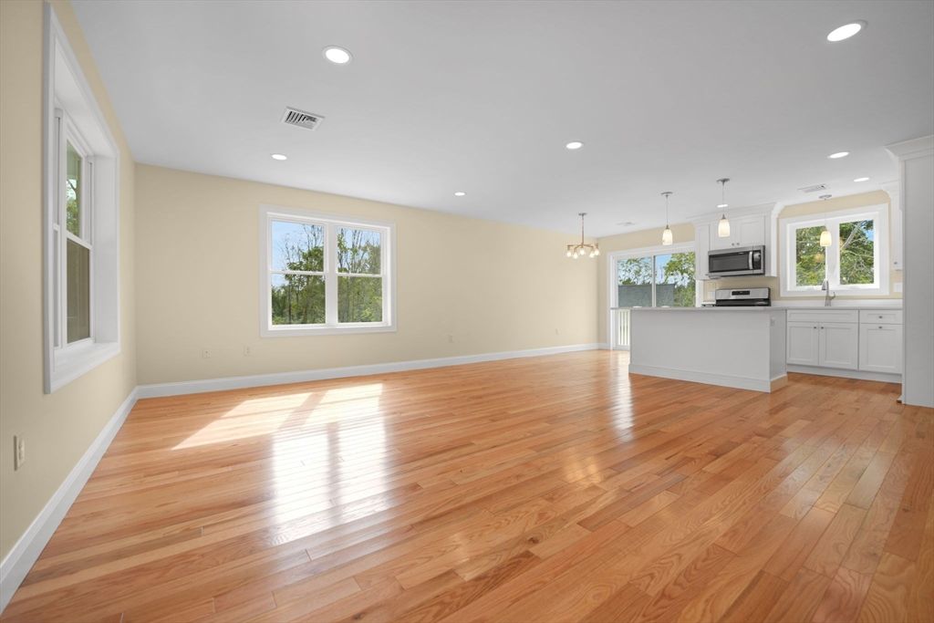 Empty room, Interior, Kitchen, Pendant Lights, Recessed Lighting, Stainless Steel Appliances, Wood Texture Flooring