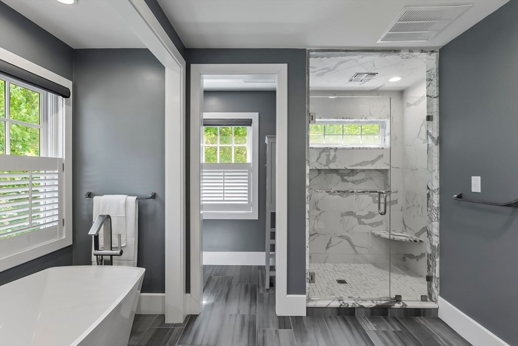 Bathroom, Free Standing Baths, Glass Shower, Interior, Marble Walls, Recessed Lighting, Wood Texture Flooring