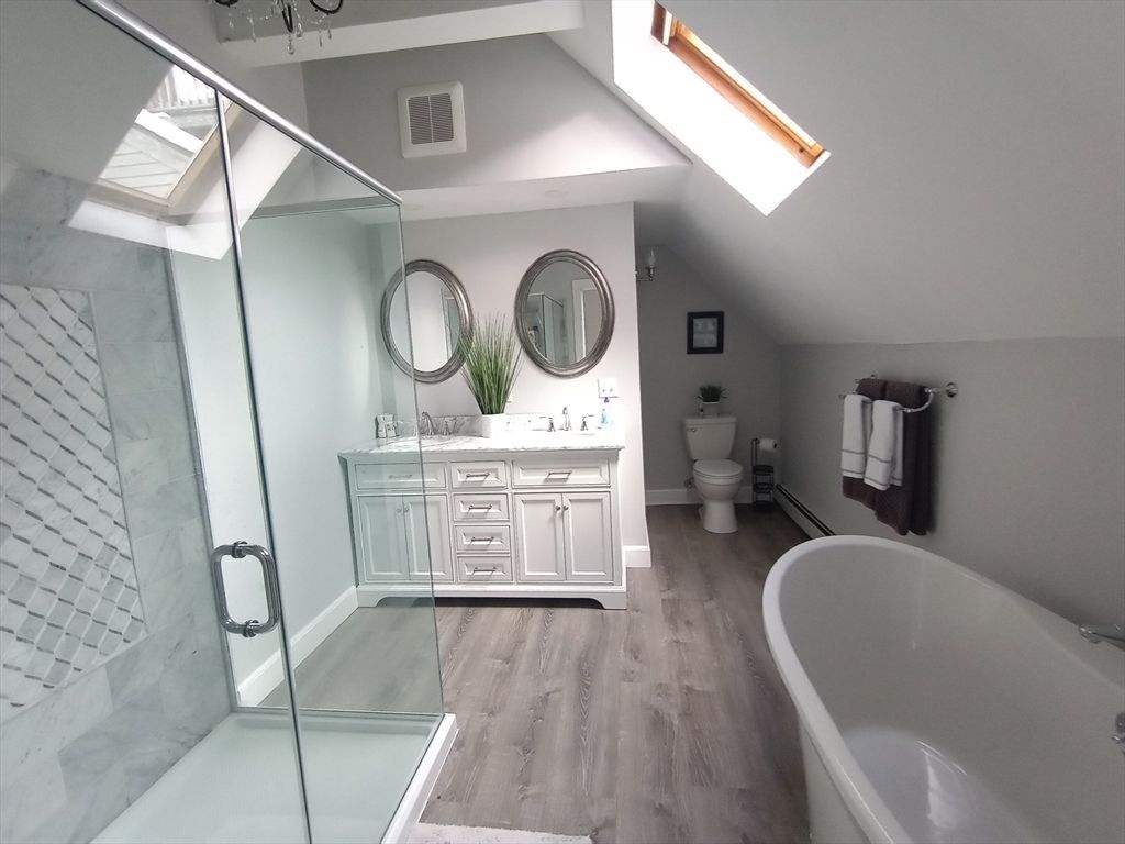 Bathroom, Dual Sink Vanities, Free Standing Baths, Glass Shower, Interior, Marble Walls, Wood Texture Flooring