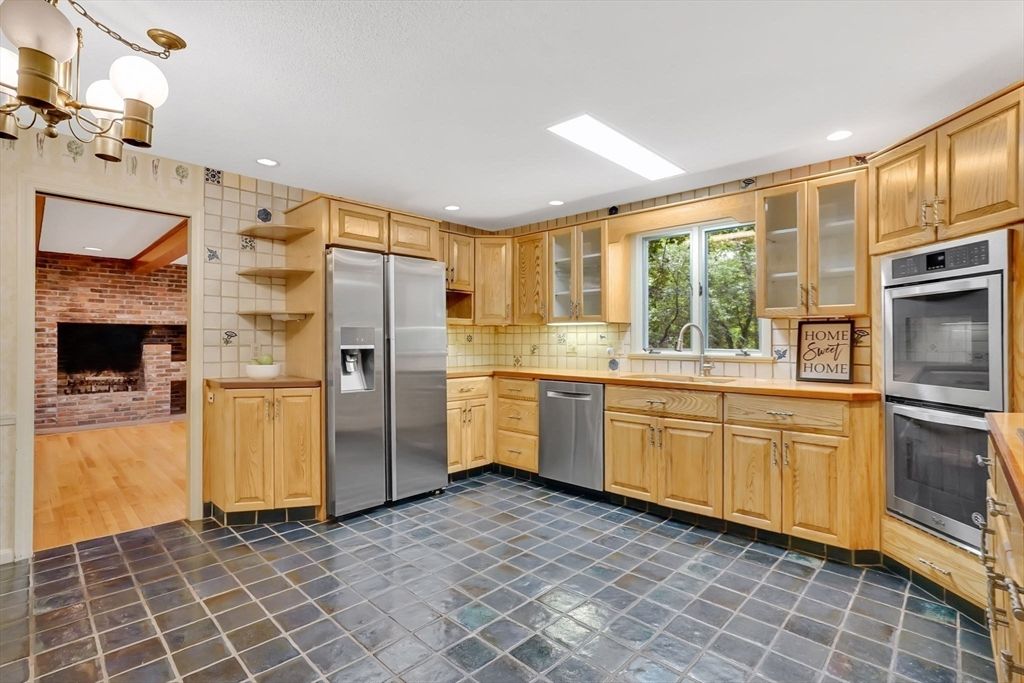 Fireplace, Interior, Kitchen, Recessed Lighting, Stainless Steel Appliances, Stone Walls, Wood Texture Flooring