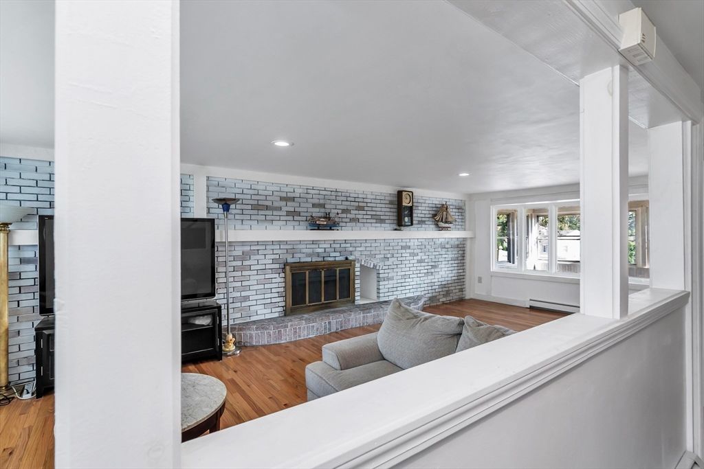 Fireplace, Interior, Living room, Recessed Lighting, Stone Walls, Wood Texture Flooring
