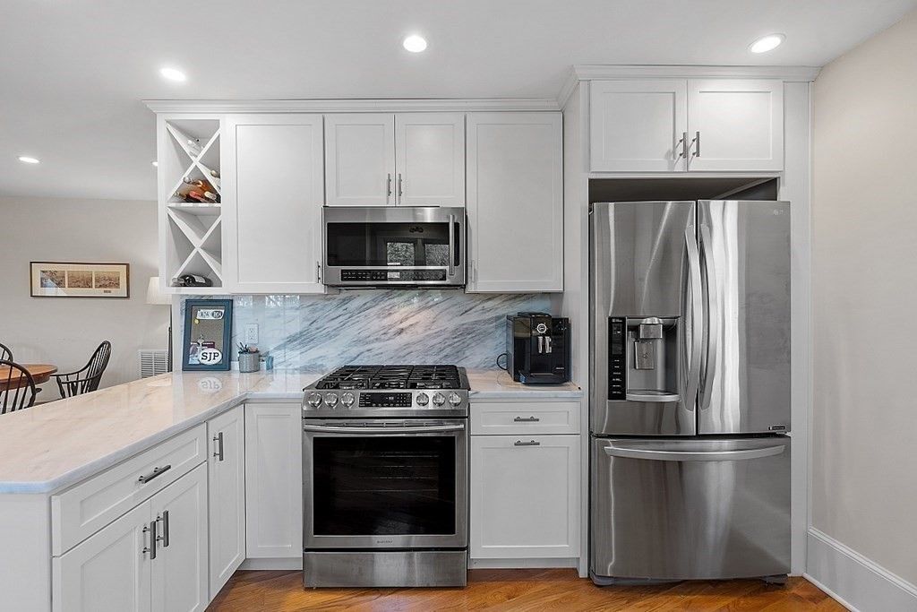 Interior, Kitchen, Marble Walls, Recessed Lighting, Stainless Steel Appliances, Wood Texture Flooring