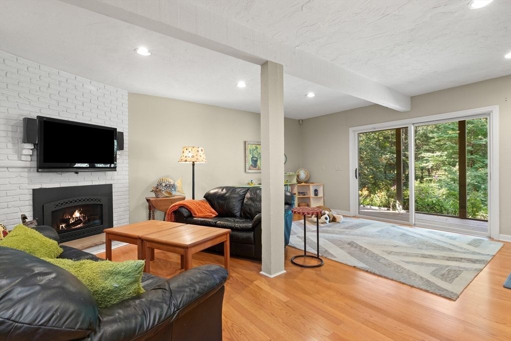 Fireplace, Interior, Living room, Recessed Lighting, Stone Walls, Wood Texture Flooring